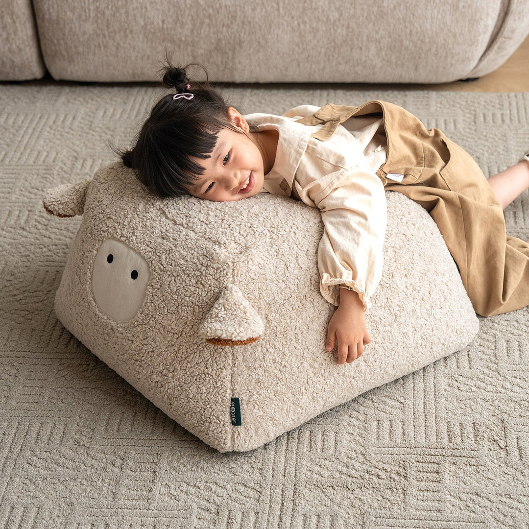 Cream boucle fabric ottoman sheep primary product view.