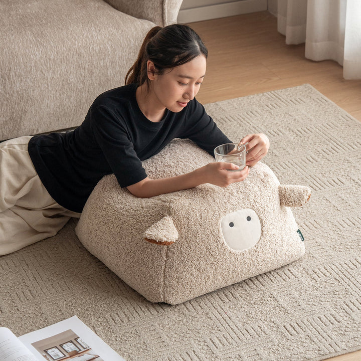 Cream boucle fabric ottoman sheep size charts.
