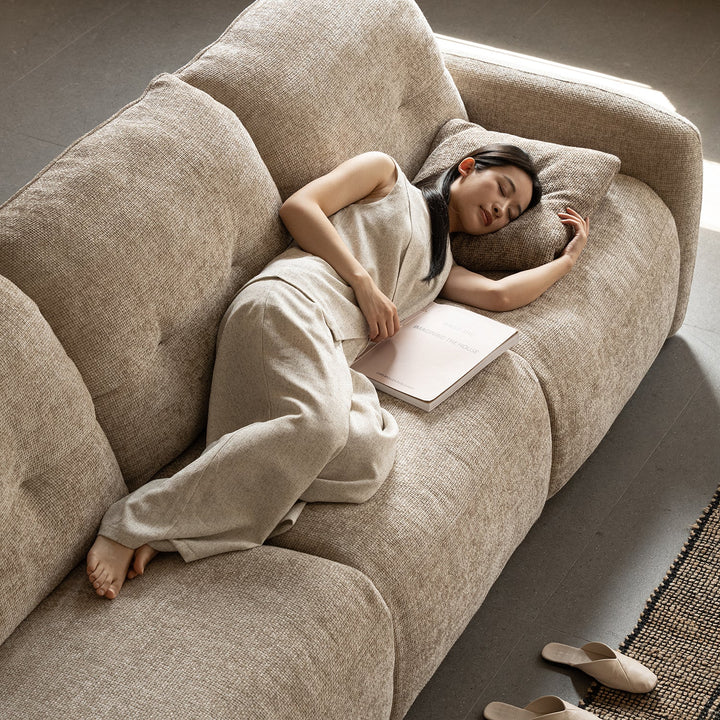 Cream chenille velvet fabric recliner 2 seater sofa mellow in close up details.