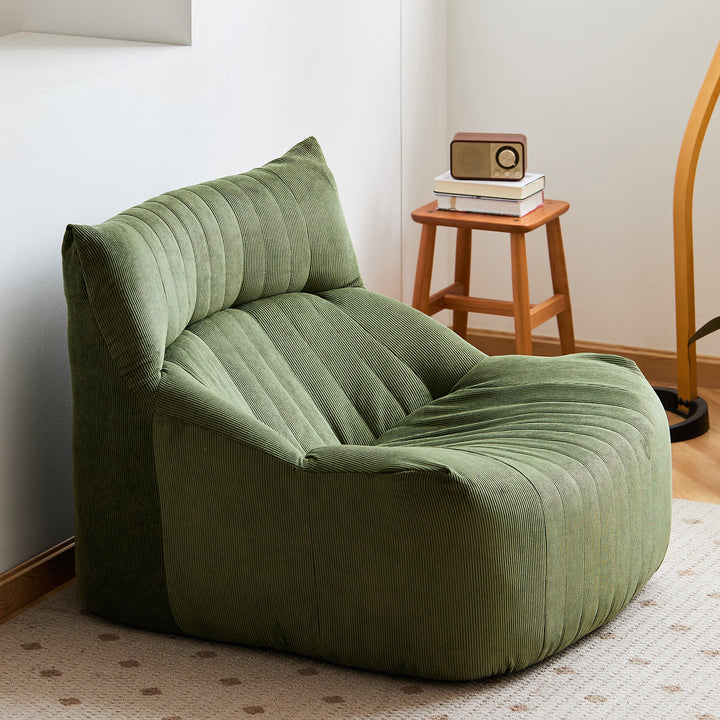 Cream corduroy velvet fabric 1 seater sofa kait with context.