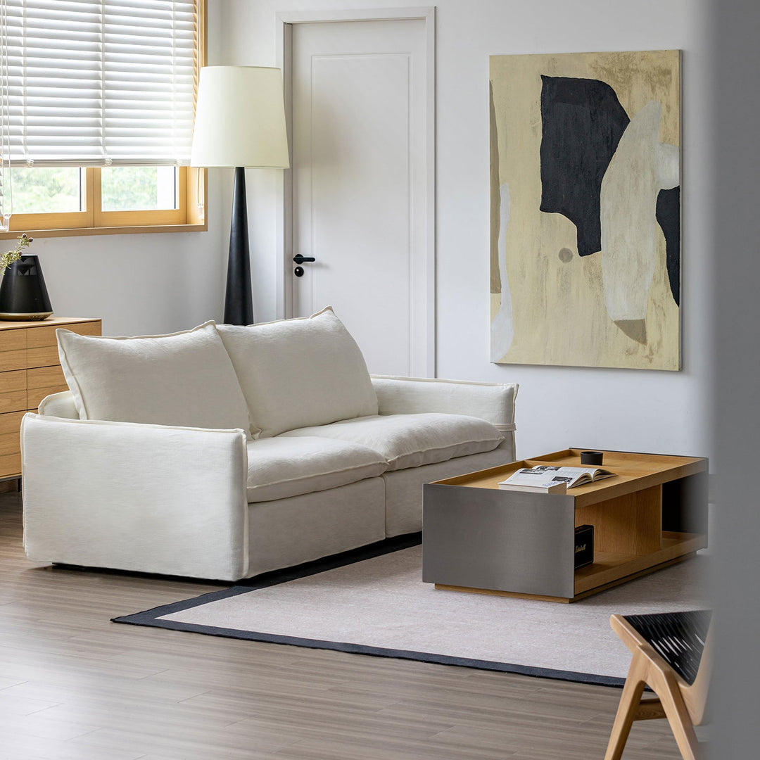 Cream cotton fabric 2 seater sofa folding ear in details.