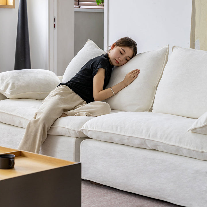 Cream cotton fabric 4 seater sofa folding ear in panoramic view.