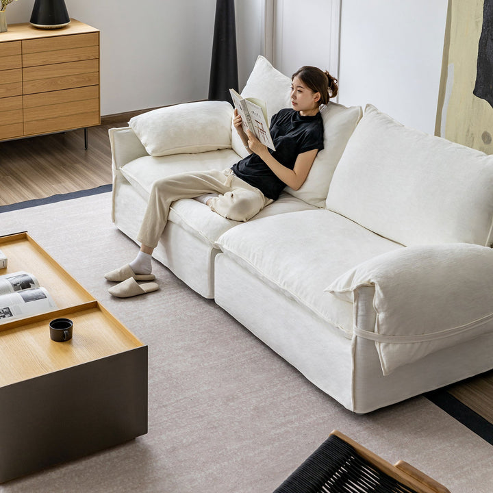 Cream cotton fabric 4 seater sofa folding ear in still life.