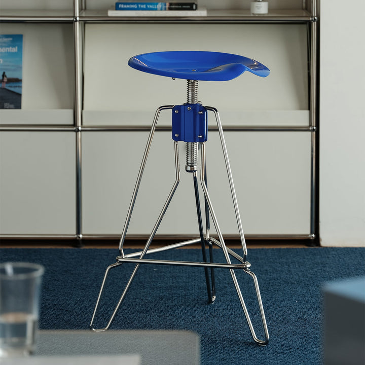 Industrial steel height adjustable bar chair spool in still life.