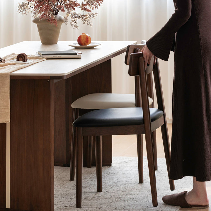Japandi walnut wood microfiber leather dining chair green in close up details.