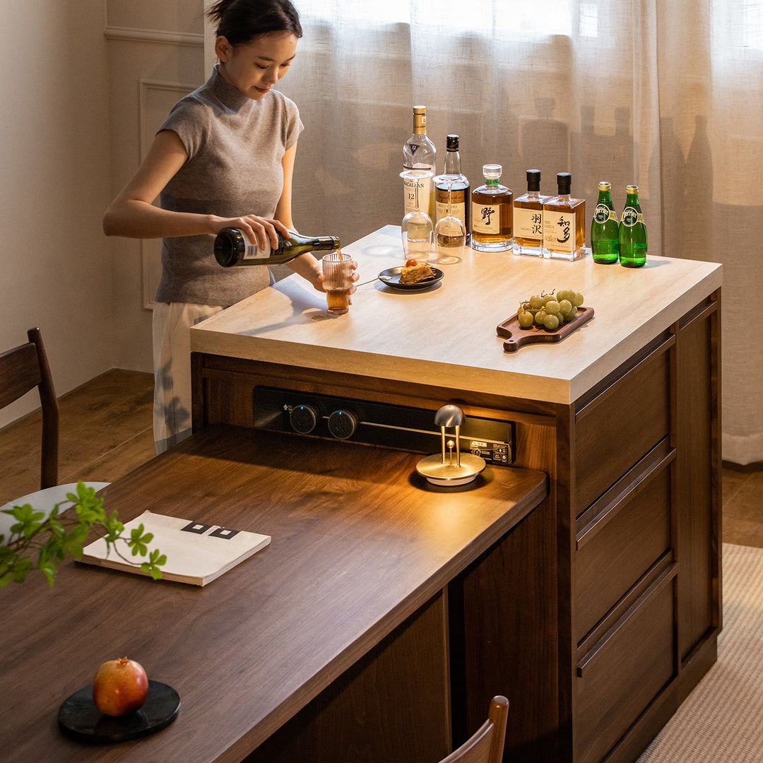 Japandi walnut wood sintered stone island dining table with cabinet axis with context.