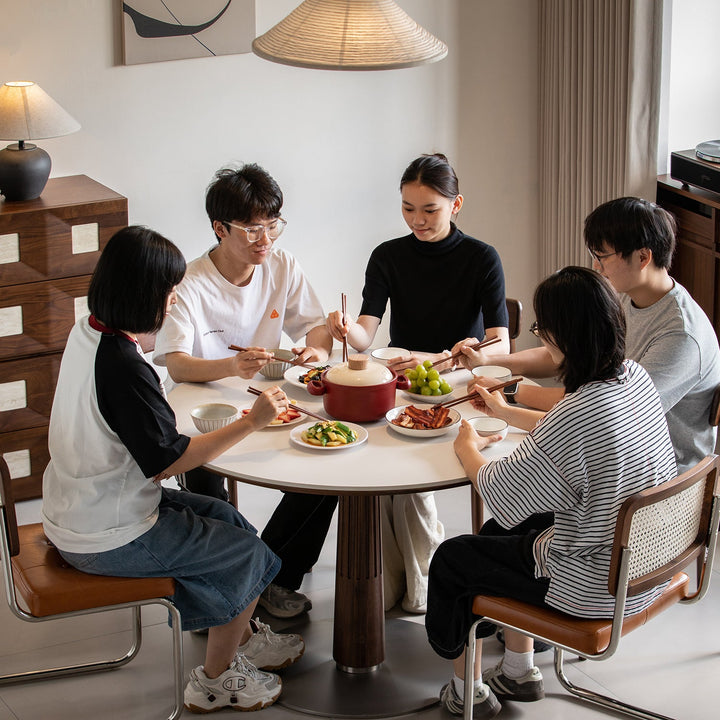 Japandi walnut wood sintered stone round dining table grey in details.
