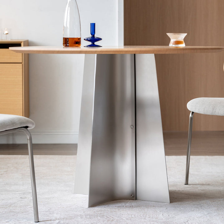 Bauhaus ash wood veneer stainless steel round dining table aeri in panoramic view.