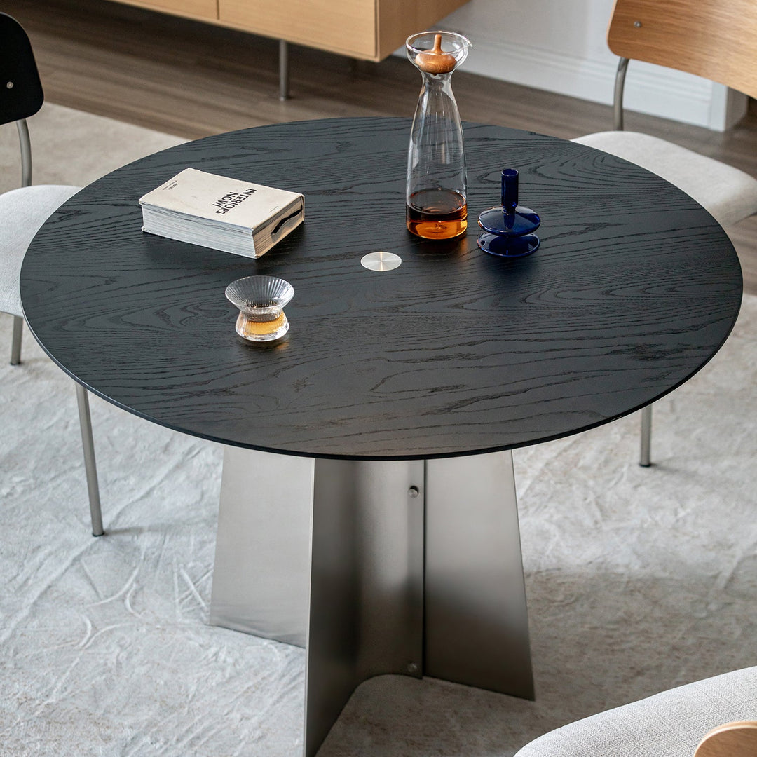 Minimalist ash wood veneer stainless steel round dining table black aeri in real life style.