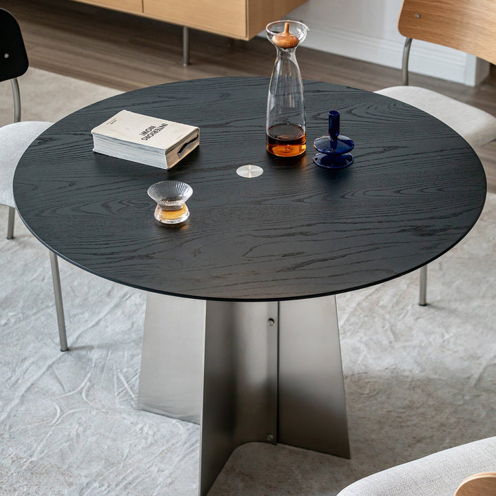 Minimalist ash wood veneer stainless steel round dining table black aeri in real life style.