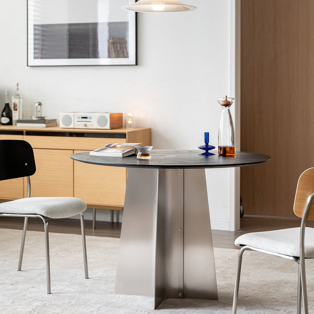 Minimalist ash wood veneer stainless steel round dining table black aeri in close up details.