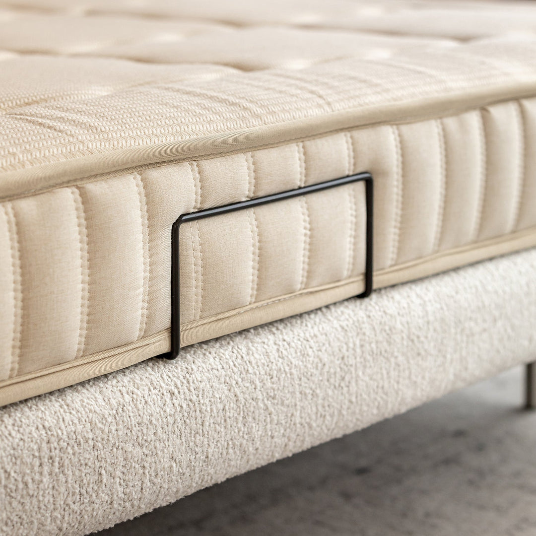 Minimalist boucle fabric bed morn in panoramic view.