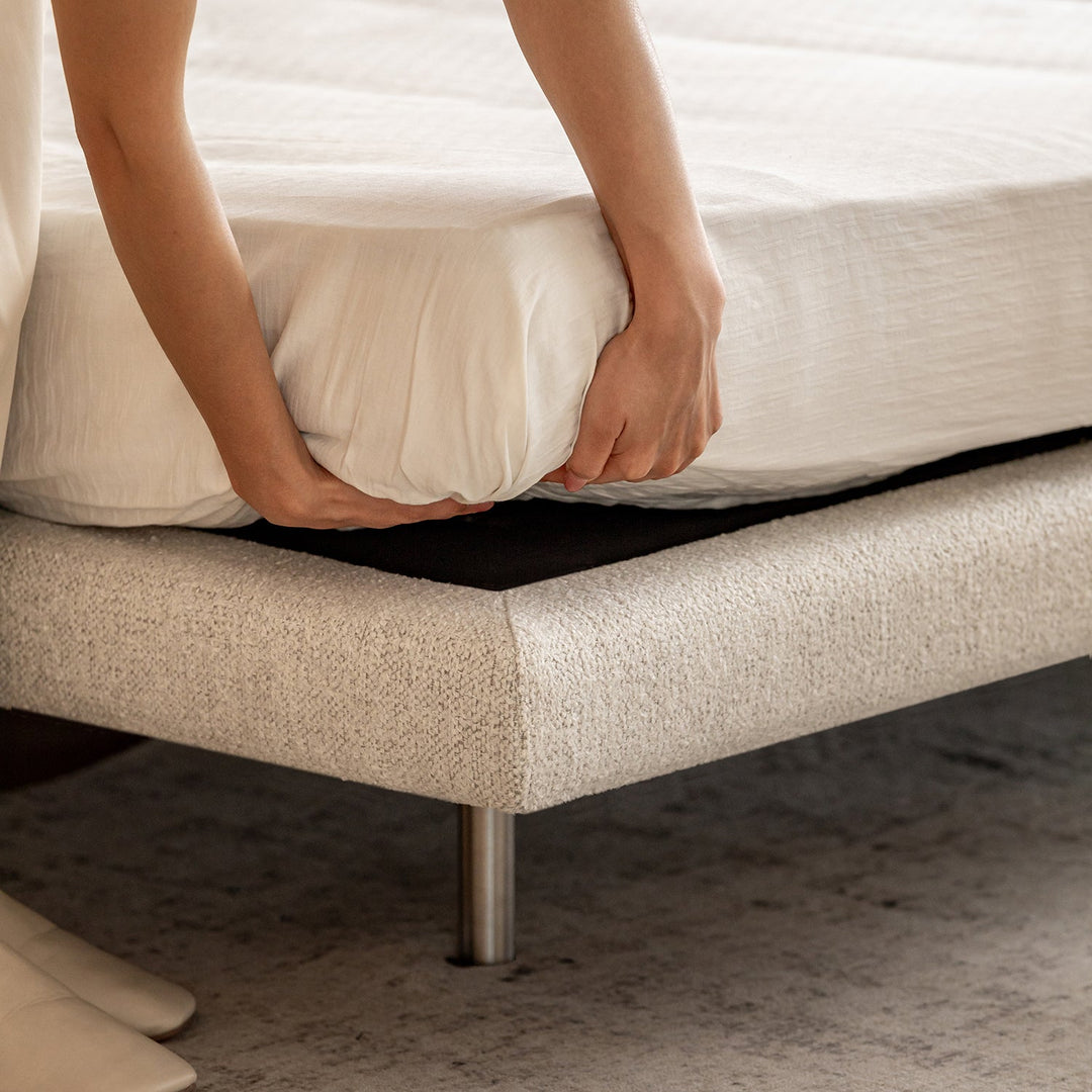Minimalist boucle fabric bed morn in details.