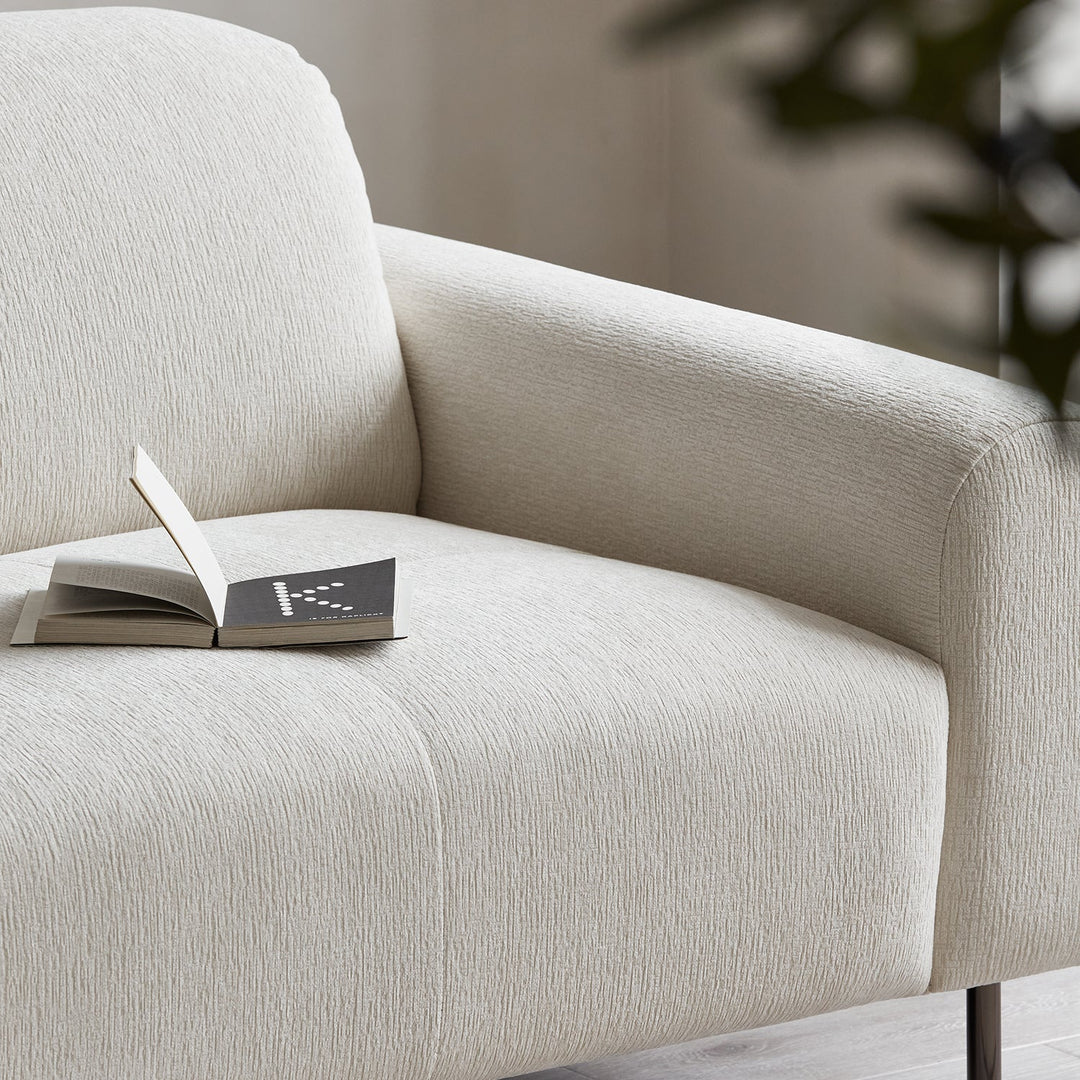 Minimalist chenille velvet fabric 1 seater sofa drift in still life.