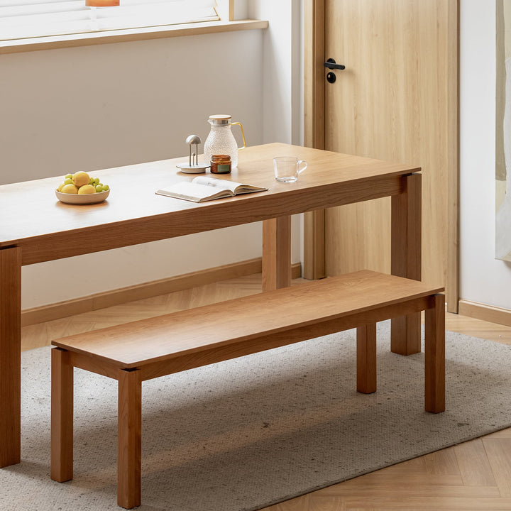 Minimalist cherry wood dining bench coastal in panoramic view.