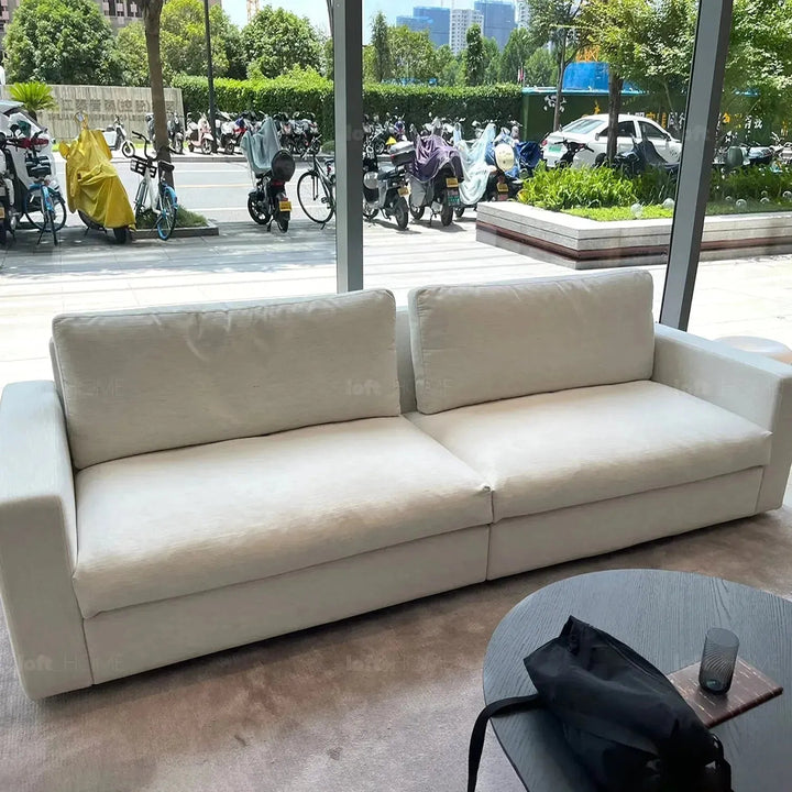Minimalist fabric 3 seater sofa white in close up details.