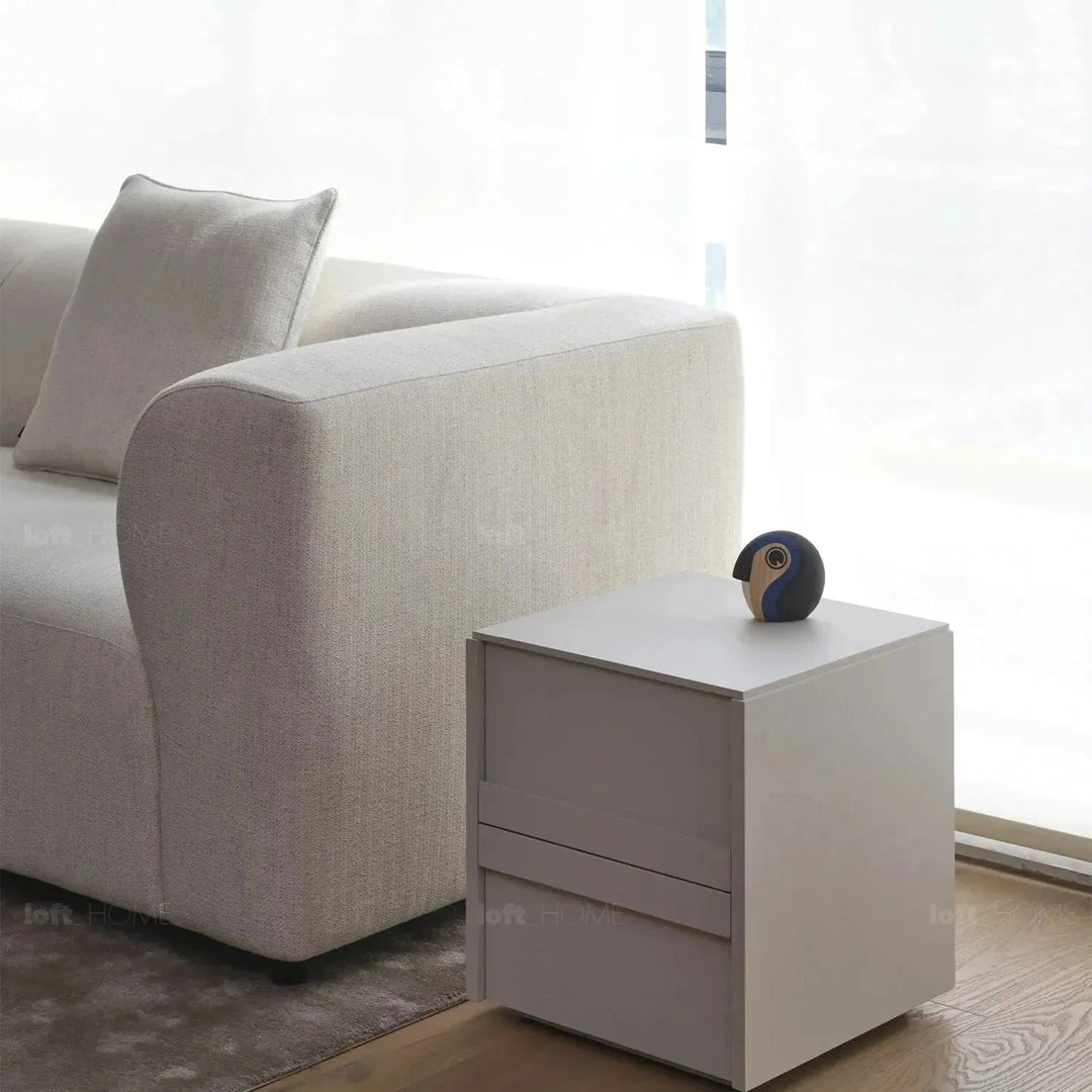 Minimalist fabric 4 seater sofa flower in close up details.