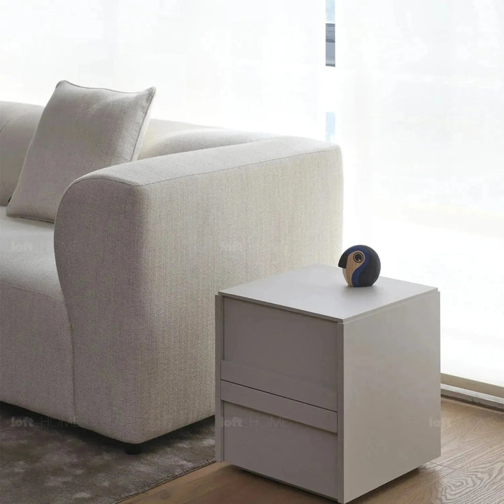 Minimalist fabric 4 seater sofa flower in close up details.