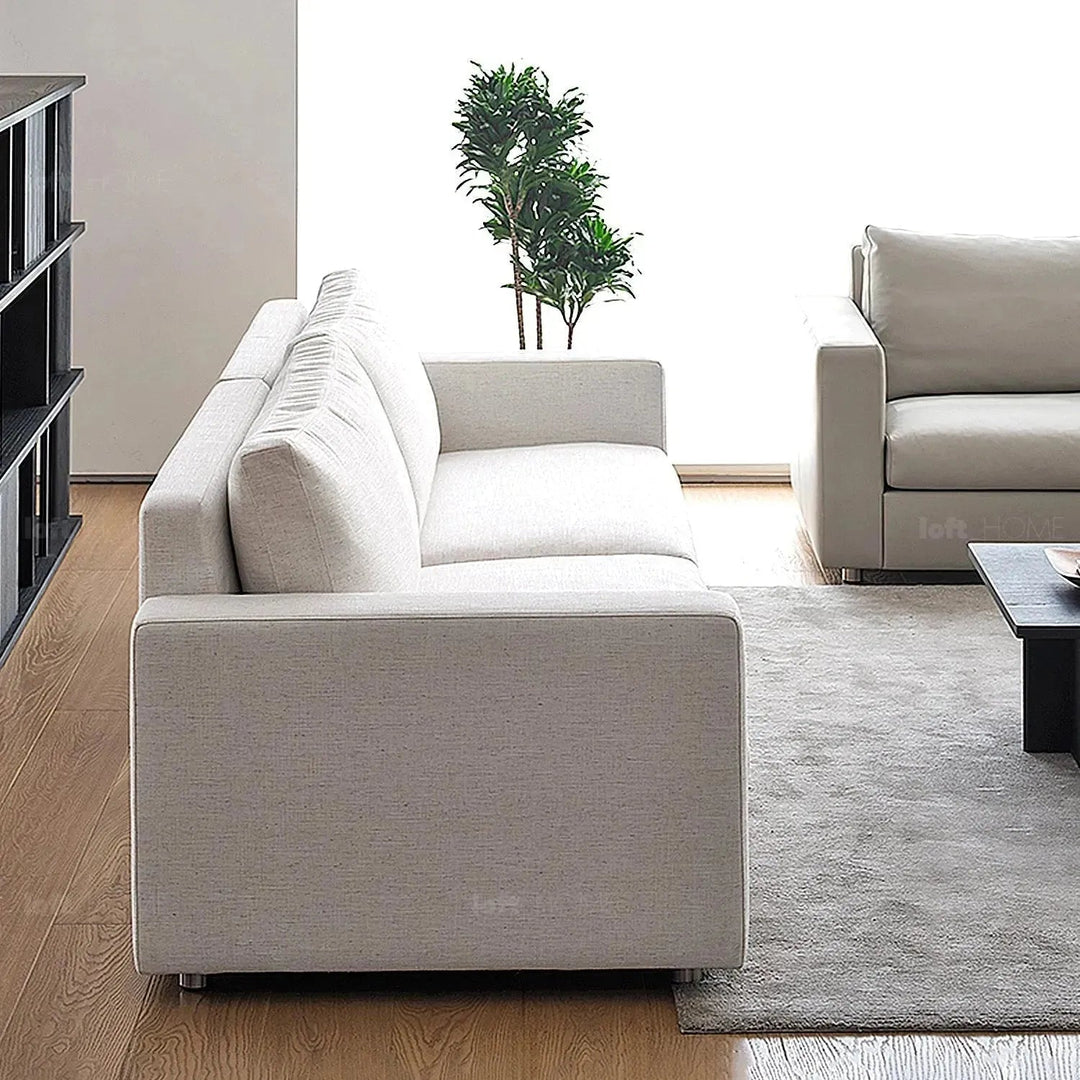 Minimalist fabric 4 seater sofa white with context.