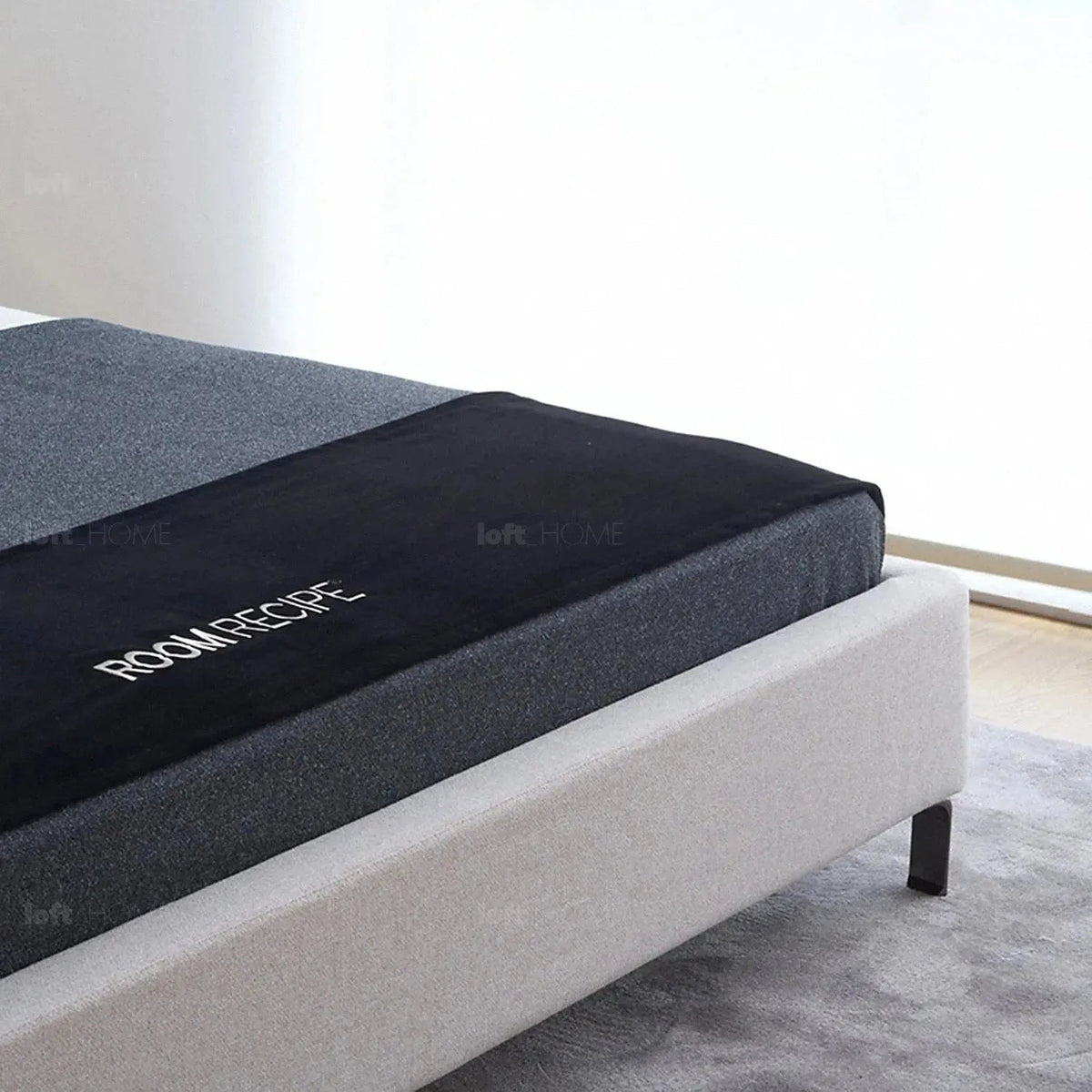 Minimalist fabric bed hel in close up details.