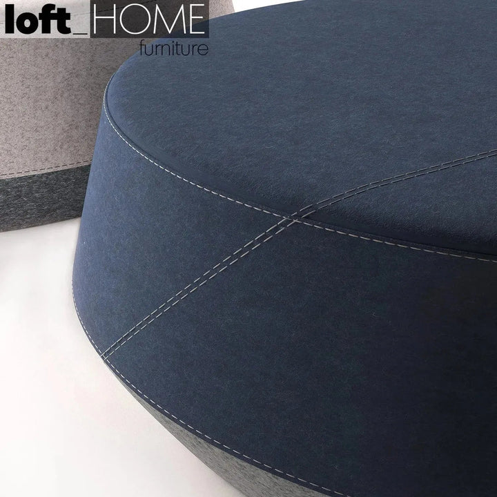 Modern fabric ottoman buono with context.