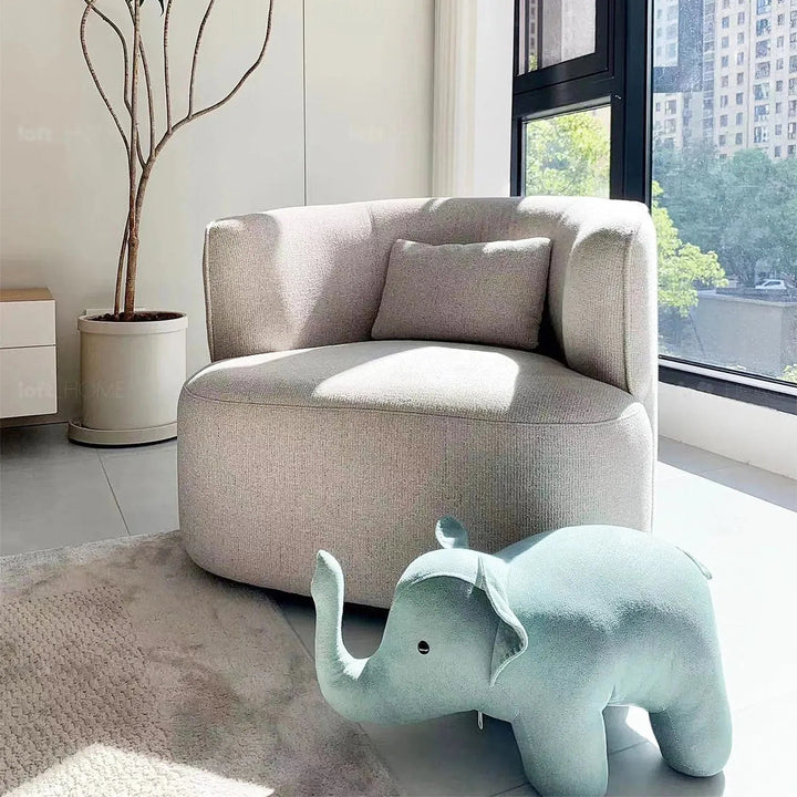Minimalist fabric revolving 1 seater sofa heb with context.