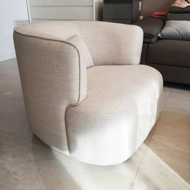 Minimalist fabric revolving 1 seater sofa heb in close up details.