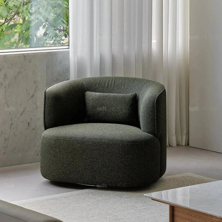 Minimalist fabric revolving 1 seater sofa heb in still life.