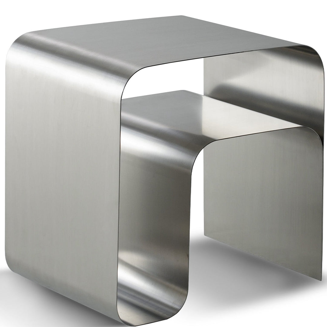 Bauhaus steel side table arc in white background.