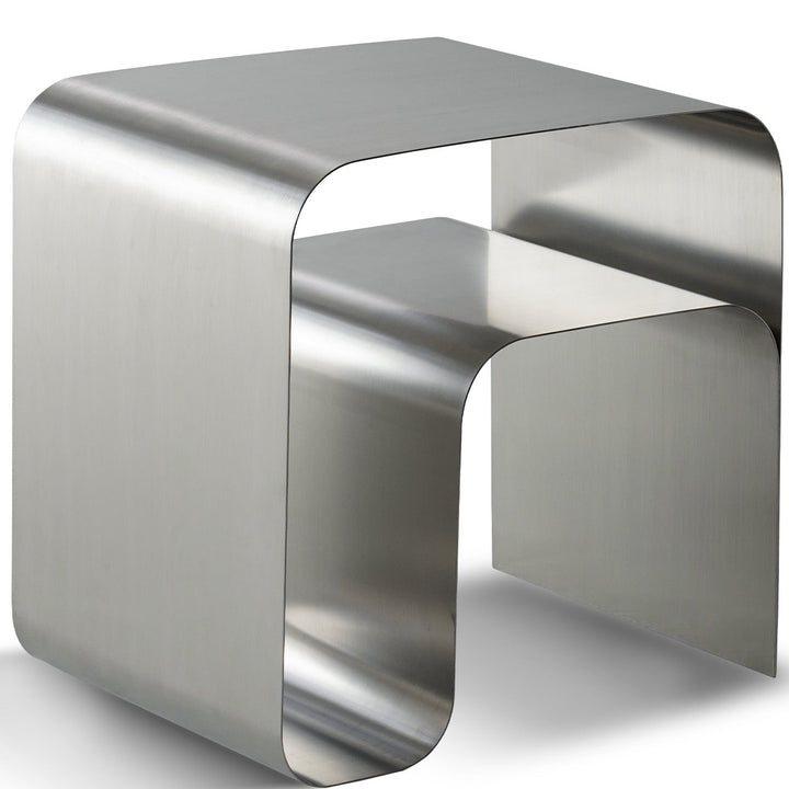 Bauhaus steel side table arc in white background.