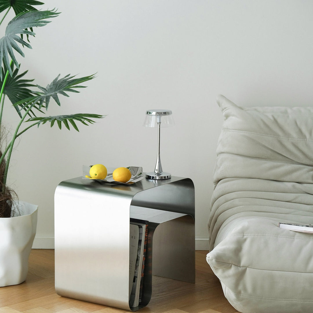 Minimalist steel side table arc with context.