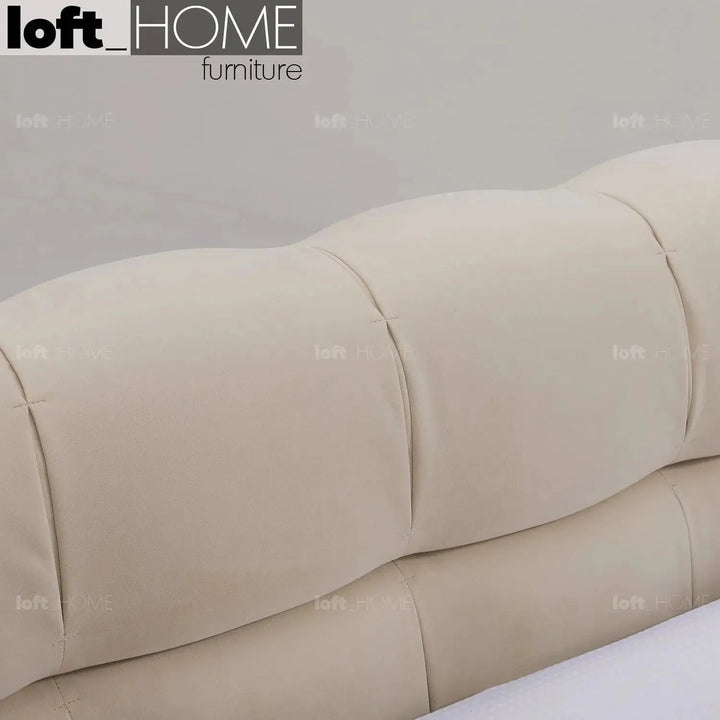 Contemporary suede fabric bed tufty in panoramic view.