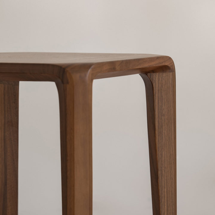 Minimalist walnut wood stool conti in still life.