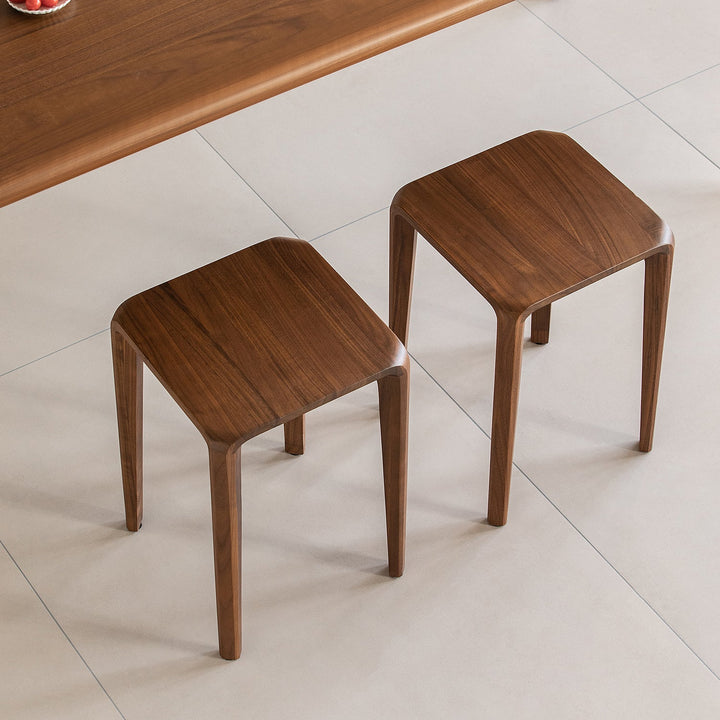Minimalist walnut wood stool conti in close up details.