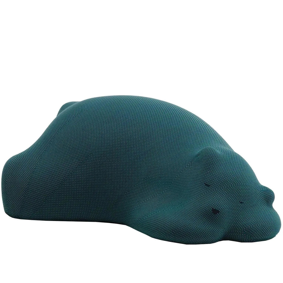 Contemporary knit fabric ottoman resting bear in white background.