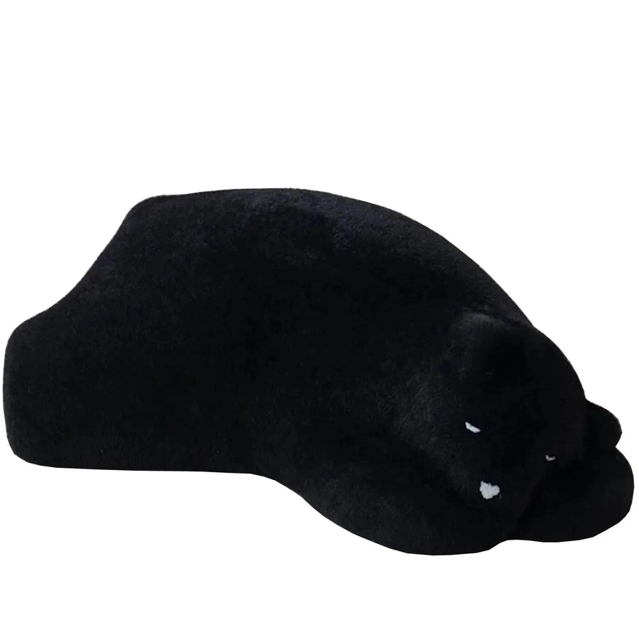Contemporary velvet ottoman resting bear black in white background.