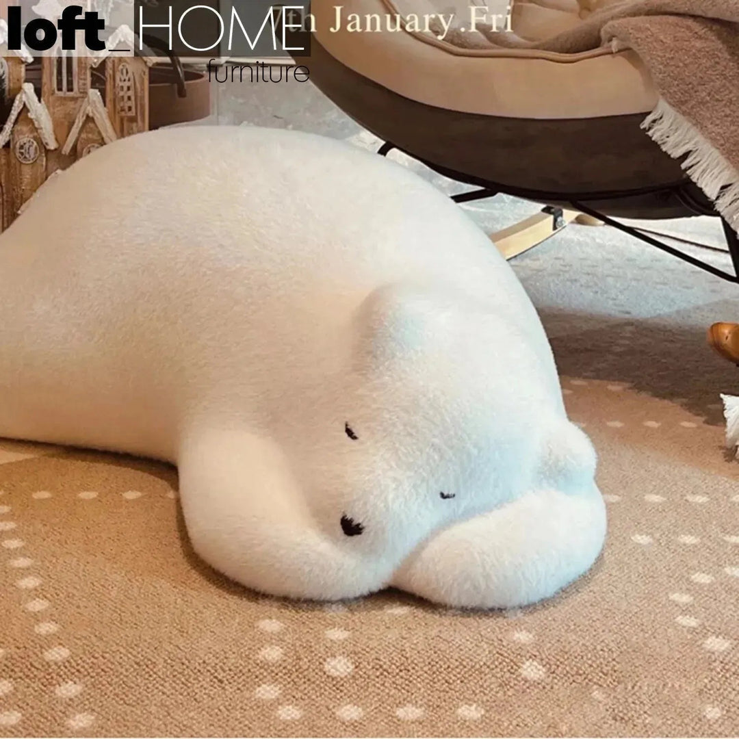 Contemporary velvet ottoman resting bear white with context.