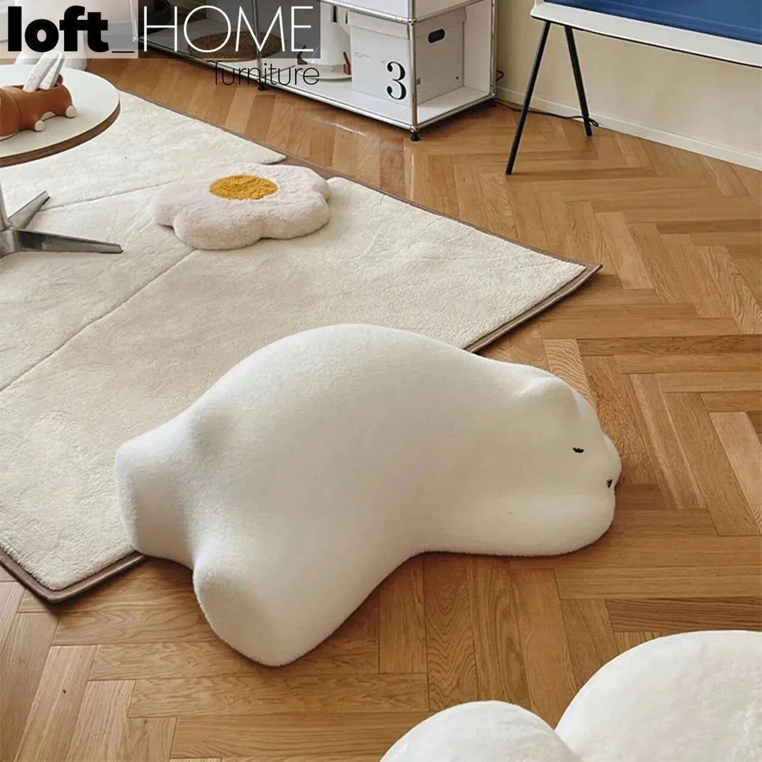 Contemporary velvet ottoman resting bear white material variants.