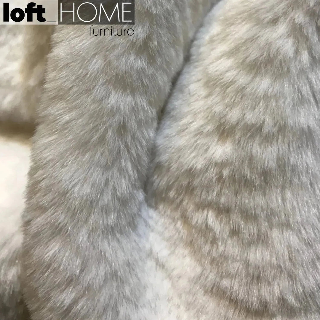 Contemporary velvet ottoman resting bear white color swatches.