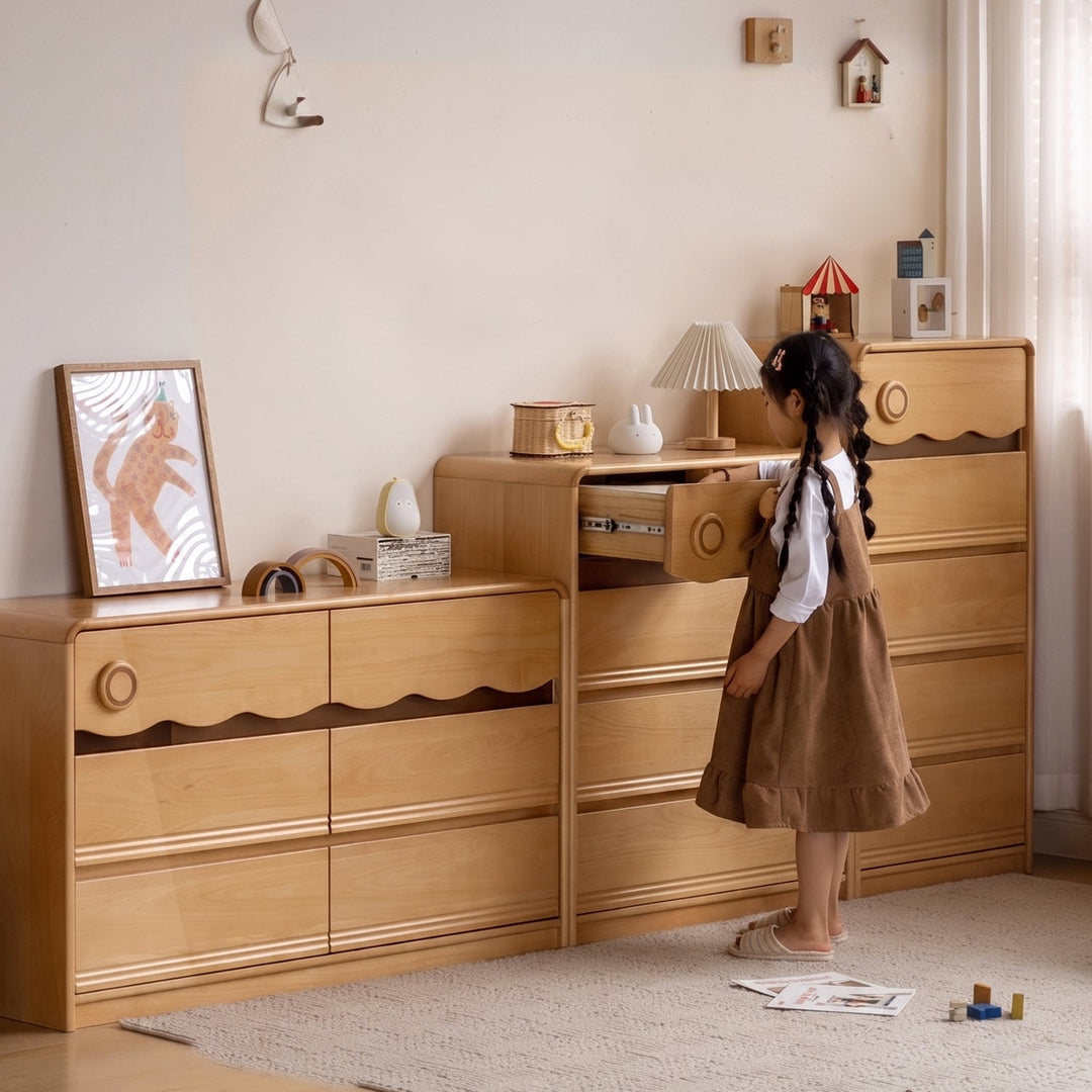 Scandinavian beech wood kids chest of drawers creamy in close up details.