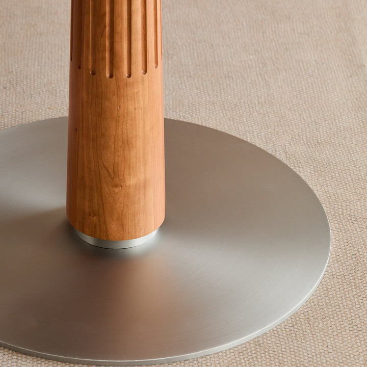 Scandinavian cherry wood sintered stone round dining table grey with context.