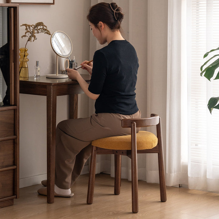 Scandinavian oak wood boucle fabric dressing chair turni in details.