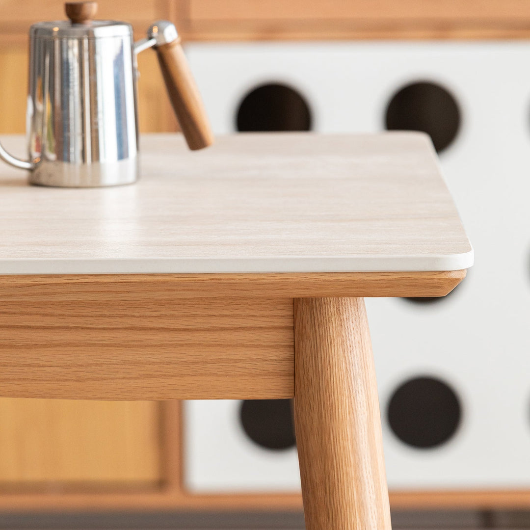 Scandinavian oak wood sintered stone dining table green in still life.