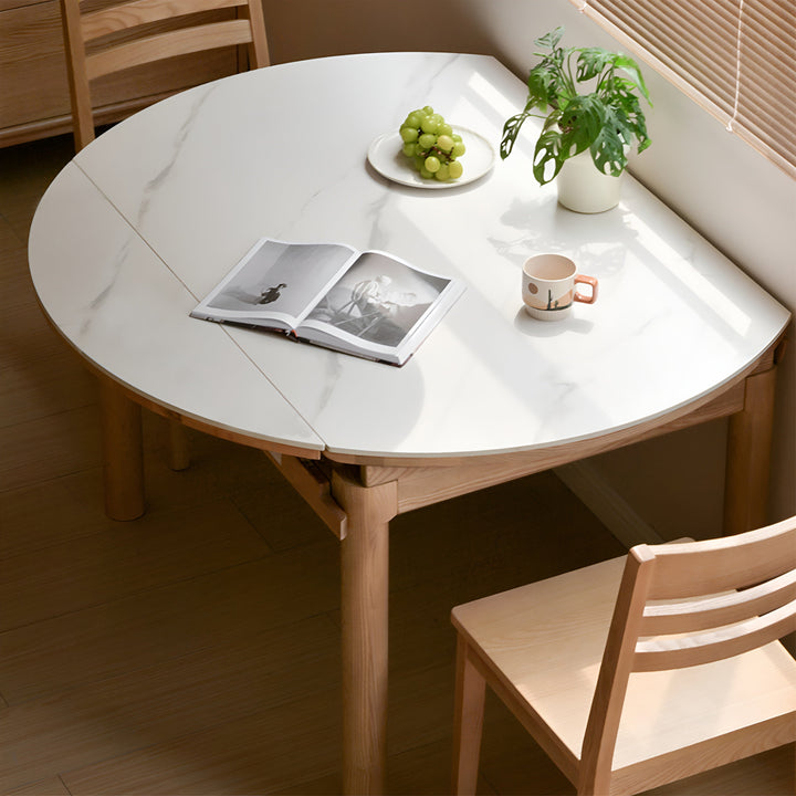 Scandinavian oak wood sintered stone extendable round dining table orbit primary product view.