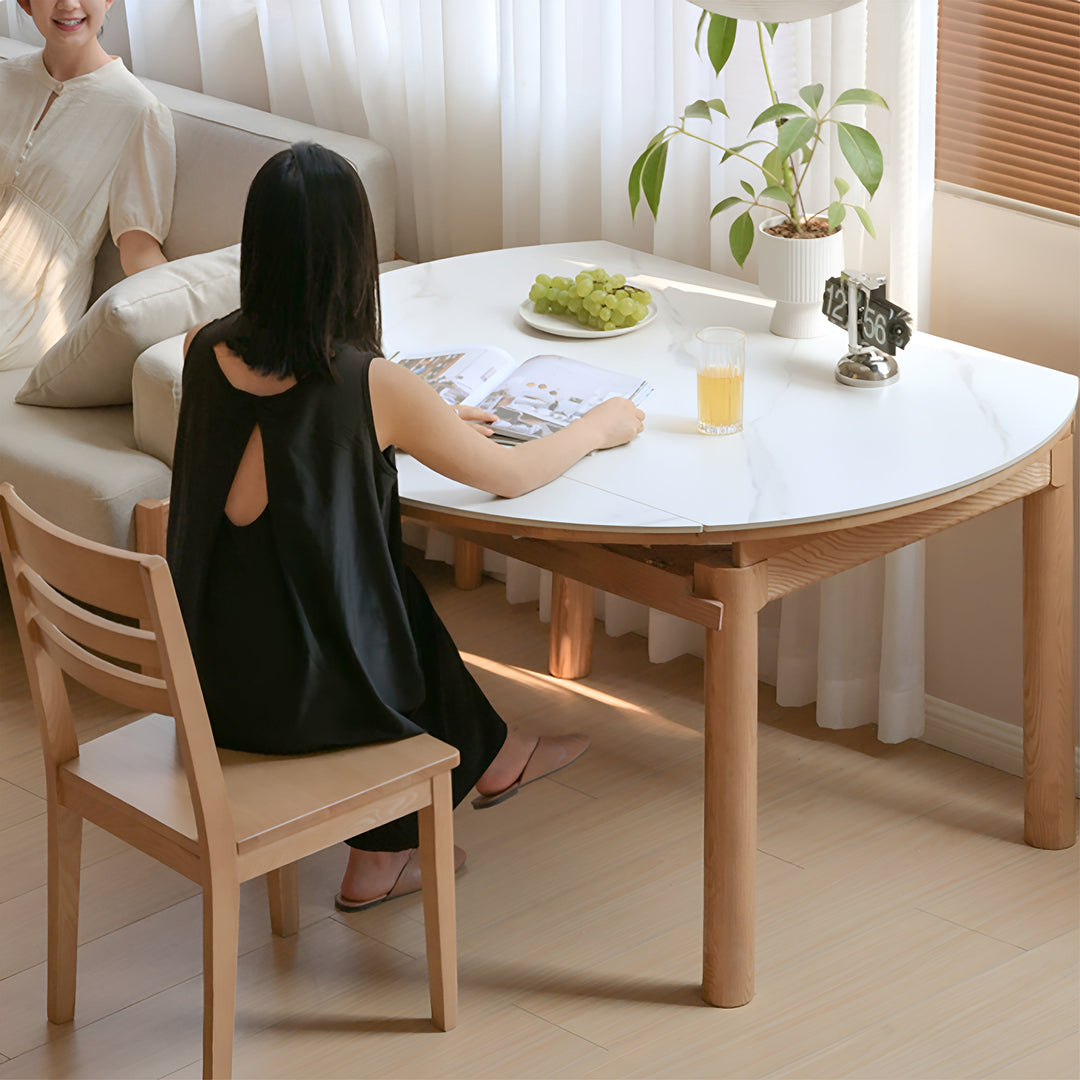 Scandinavian oak wood sintered stone extendable round dining table orbit in real life style.