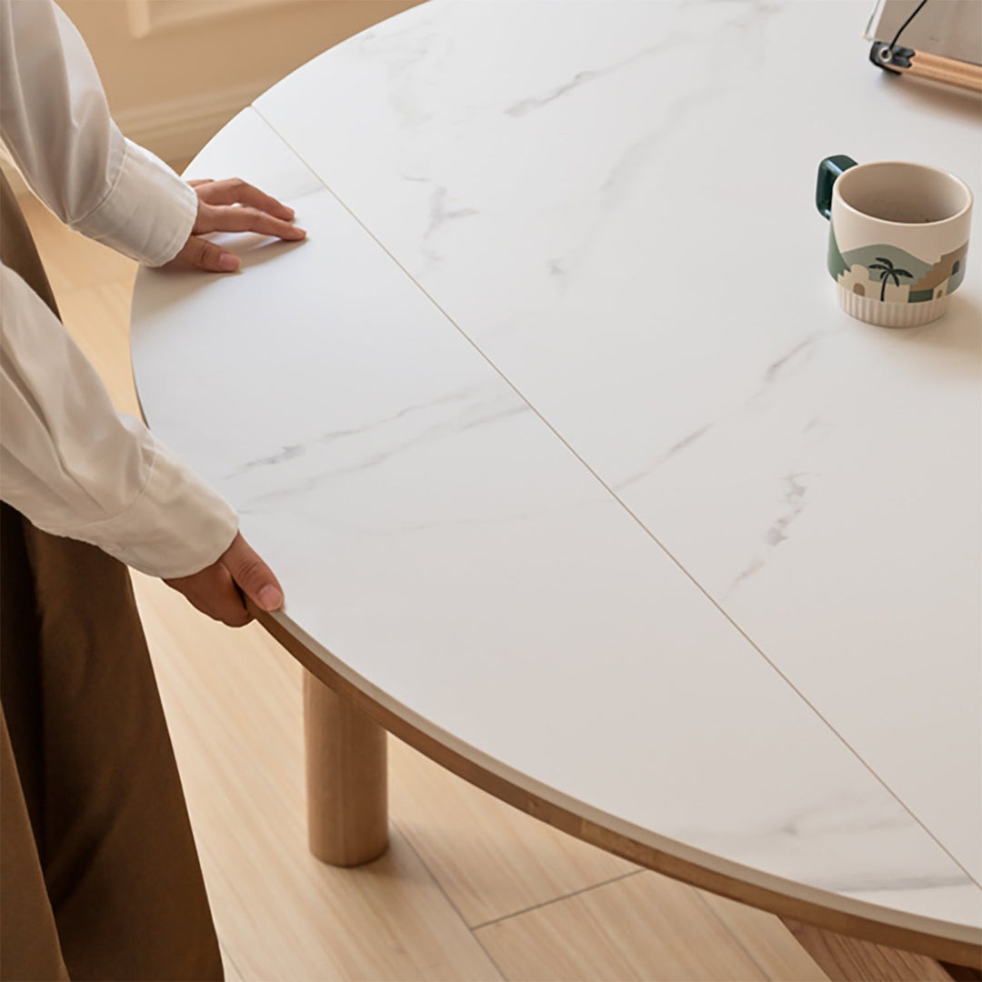 Scandinavian oak wood sintered stone extendable round dining table orbit with context.