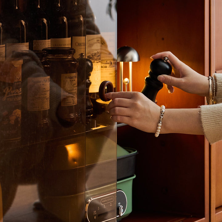 Vintage boxwood sintered stone extendable island dining table with cabinet skeletal in real life style.