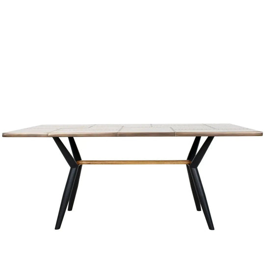 Industrial brass dining table lucien brass in white background.