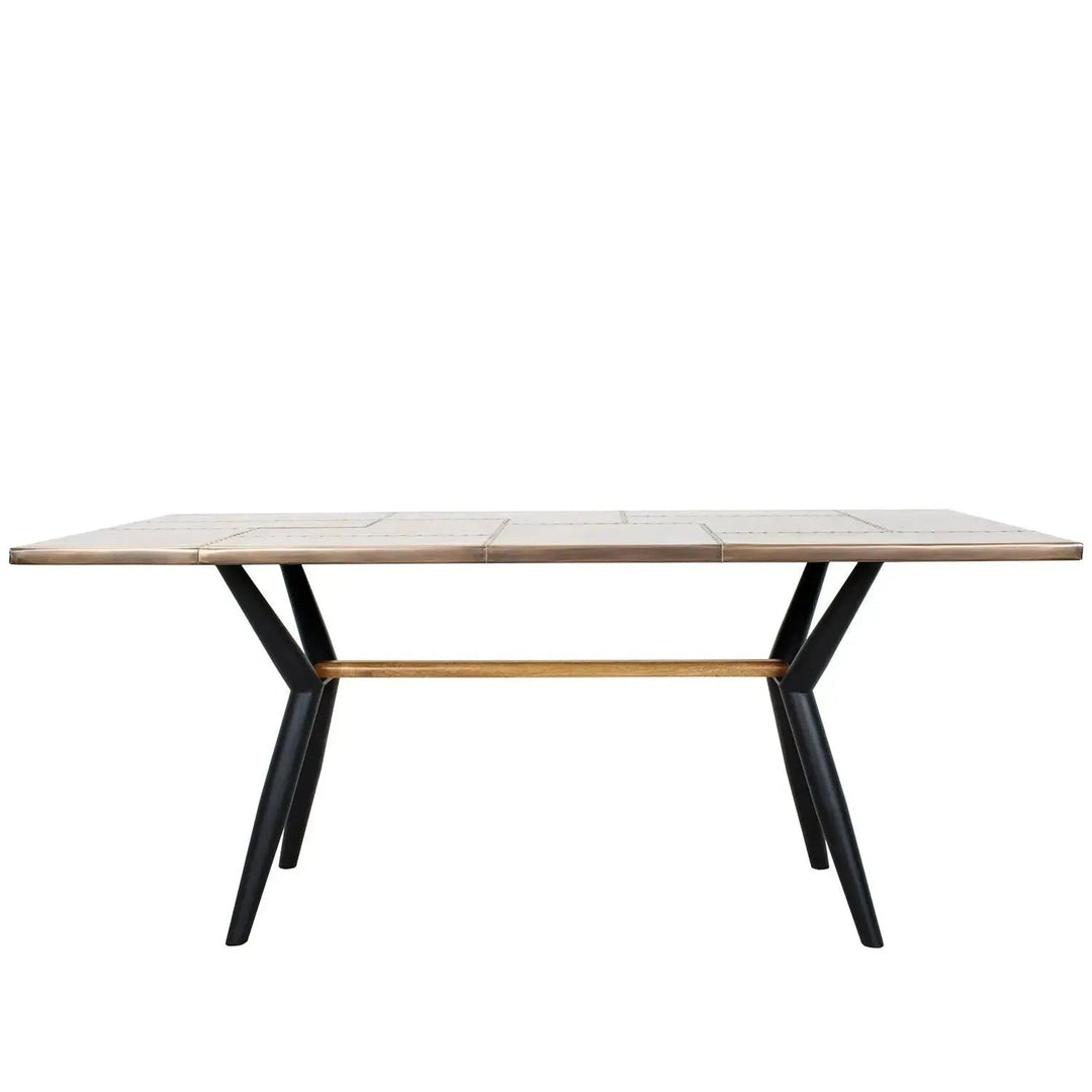 Industrial brass dining table lucien brass in white background.