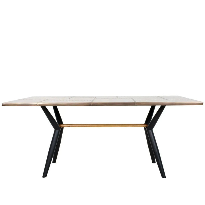 Industrial brass dining table lucien brass in white background.